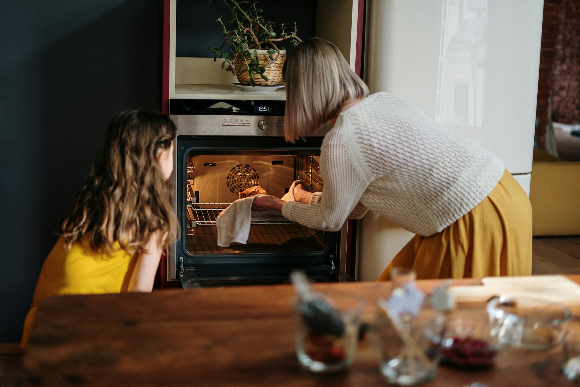 woman in white sweater baking cake